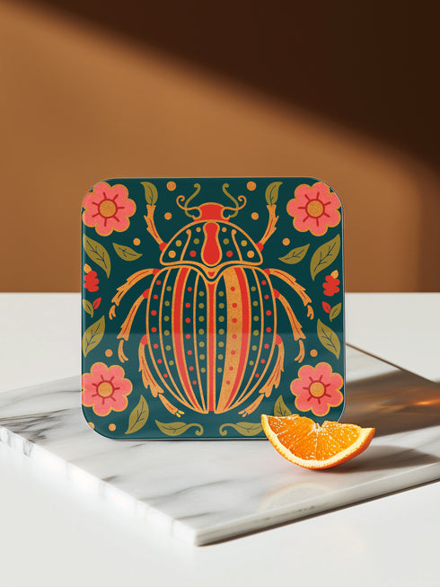 Set of 4 square Dark Academia Scarab Beetle Coasters, featuring detailed Gothic Botanical insect art prints in deep jewel tones. The hardboard coasters have a glossy finish and protective cork base. Premium Entomology Decor.